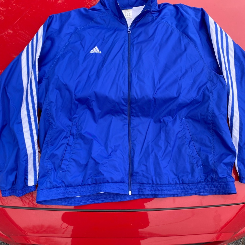 Adidas Windbreaker 
Early 2000s 
deep blue w/ stripes along the back to sleeve